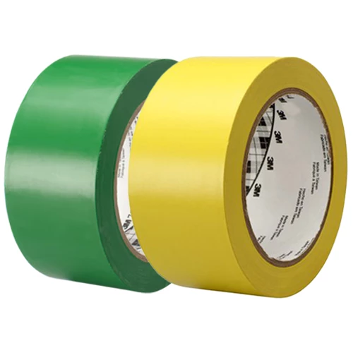 Vinyltejprullar i färgerna grön och gul.